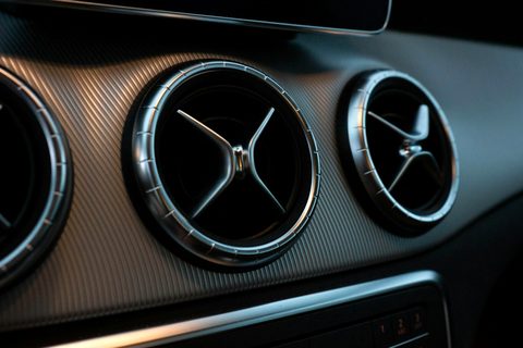 Round dashboard air vents of a car, seen close up