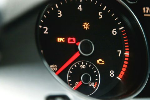 Amber check engine light lit on the dashboard next to the tachometer